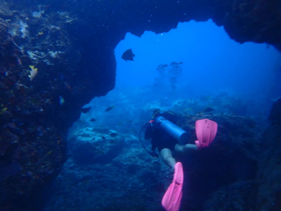 Scuba Diver with pink flippers in cave