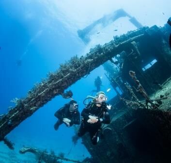scuba divers and ship wreck